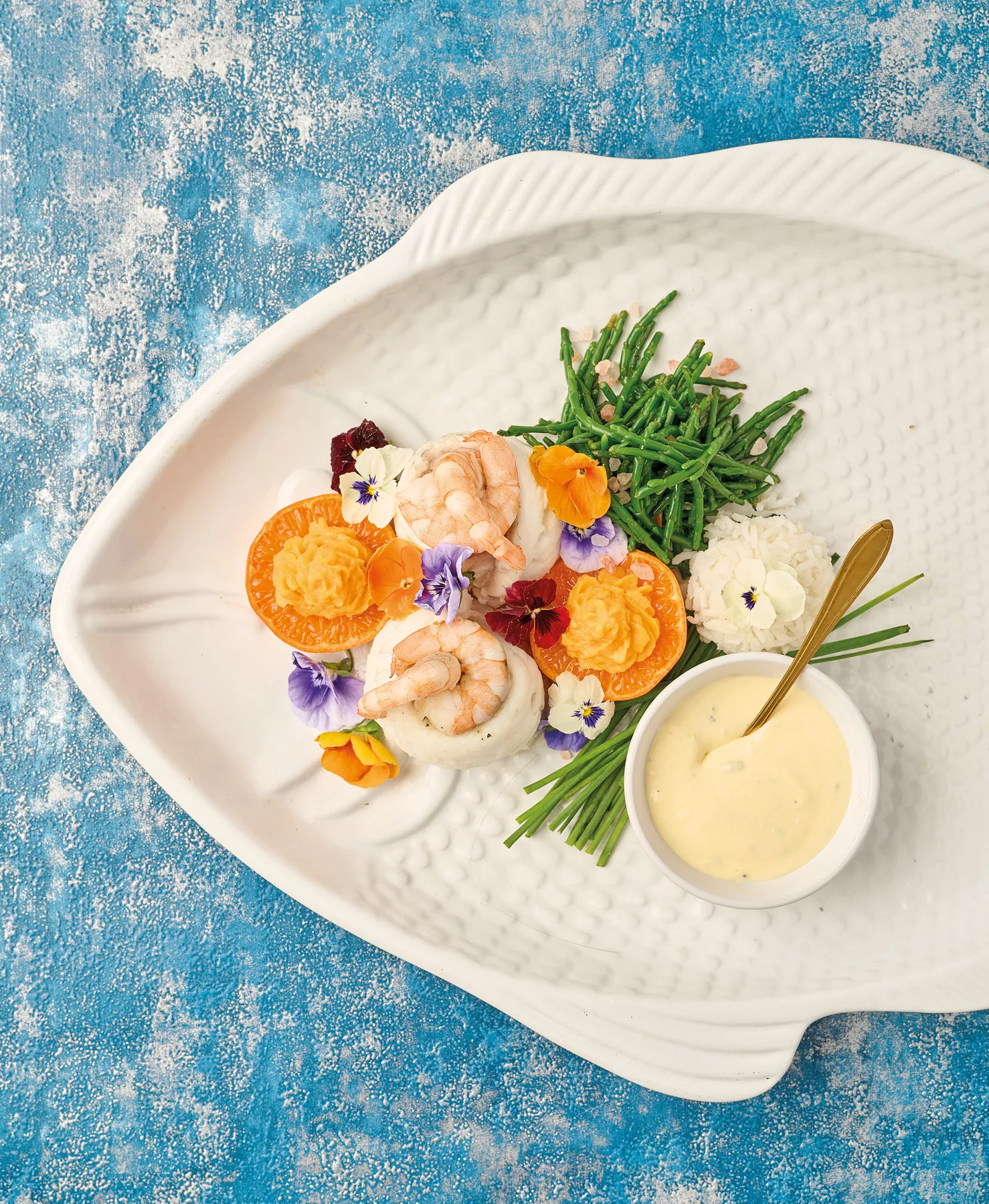 Lemon sole and king prawn flowers with a triffle cheddar and tangerine sauce and butternut mash
