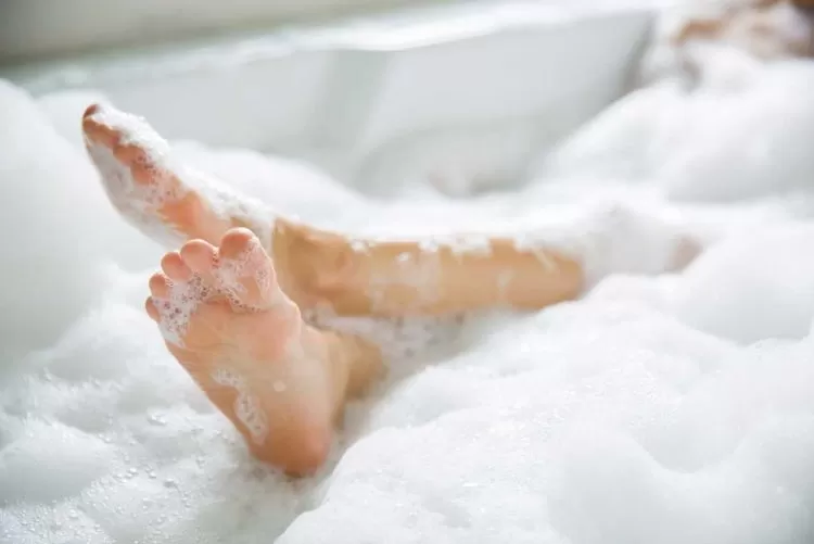 Feet in bubble bath. Image from the Ben Todd Plumbing website. Graphic design and web development by We Make Media